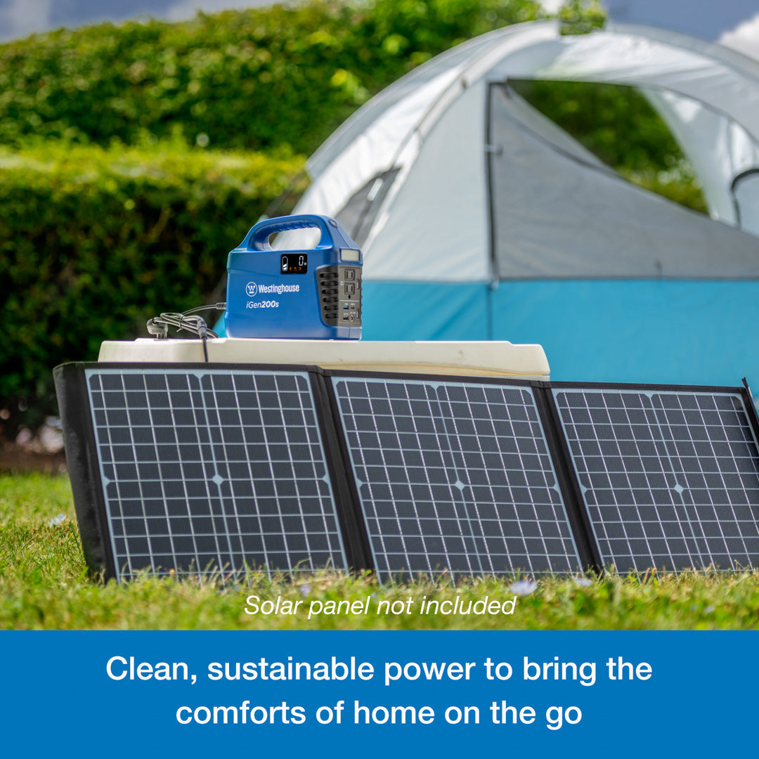 Westinghouse | iGen200s Portable Power Station sits atop a cooler. Leaning against the cooler are three solar panels that are plugged into the power station. A blue banner at the bottom reads, "Clean, sustainable power station that powers the comforts of home on the go".