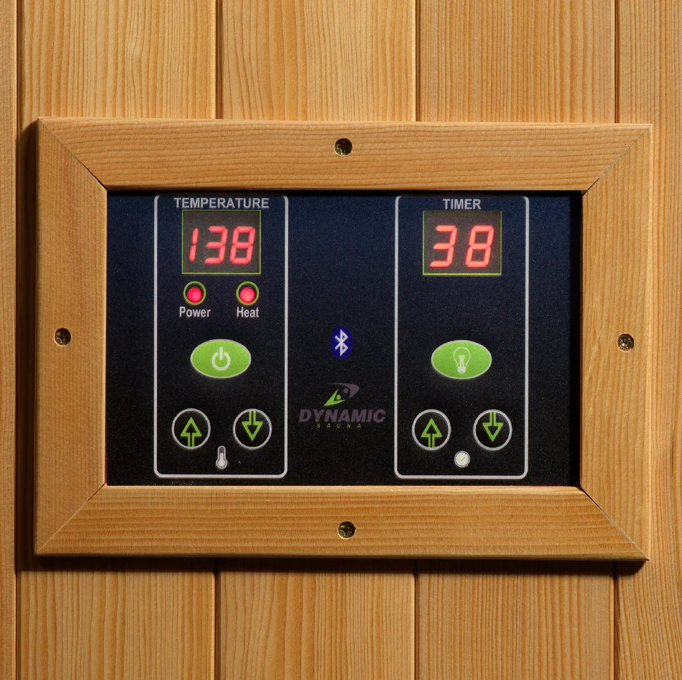 Digital sauna control panel with temperature and timer display on a wooden background