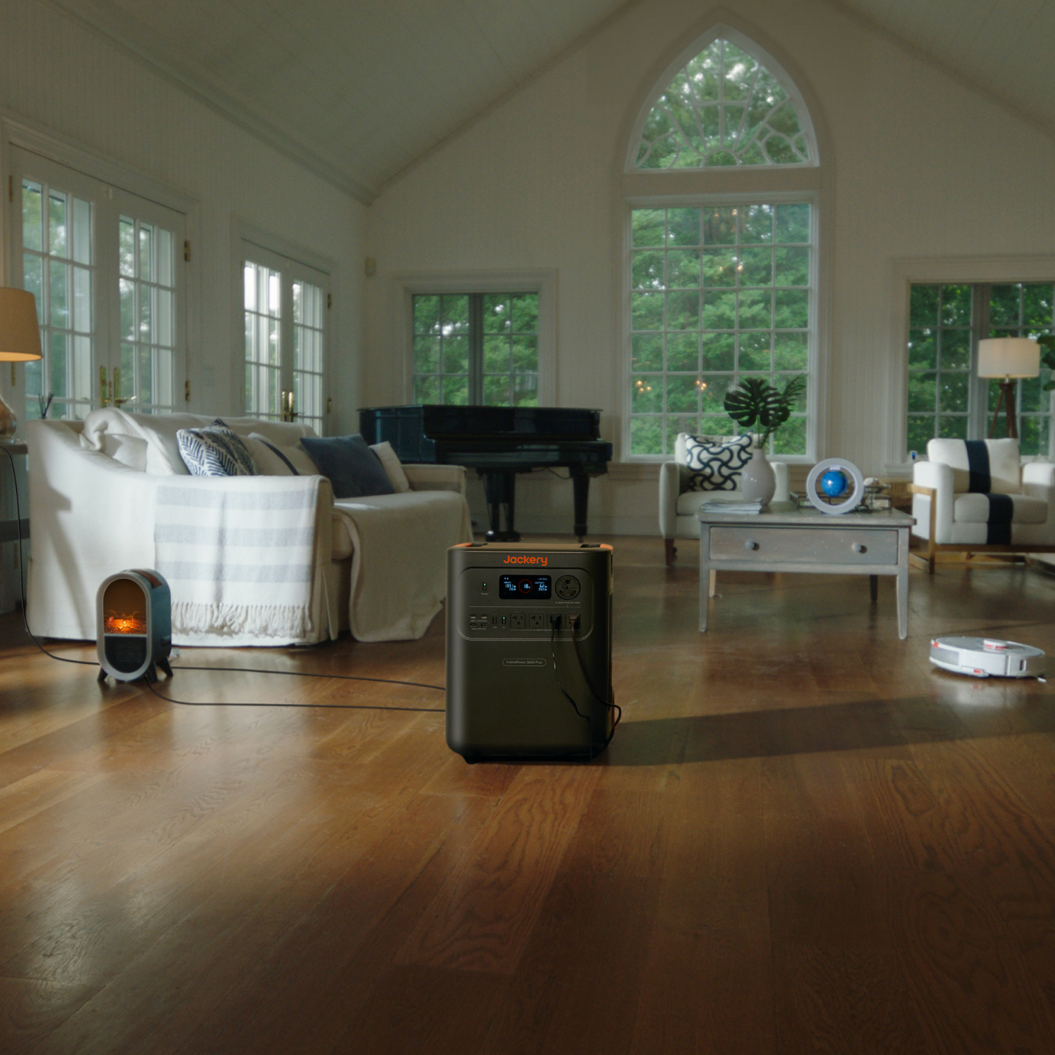 Living room with Jackery HomePower 3600 Plus Portable Power Station on a wooden floor, surrounded by furniture and decor.